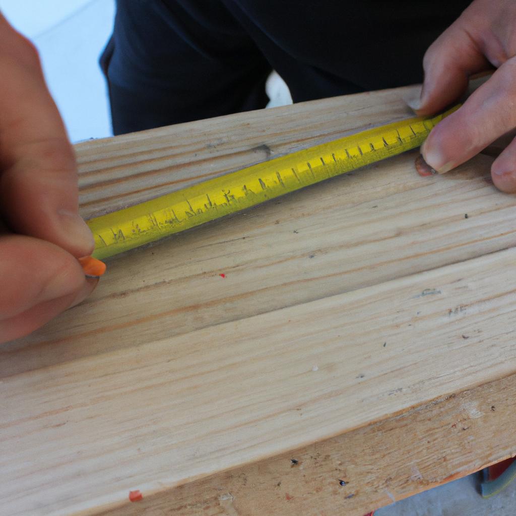 Person measuring wood with tape