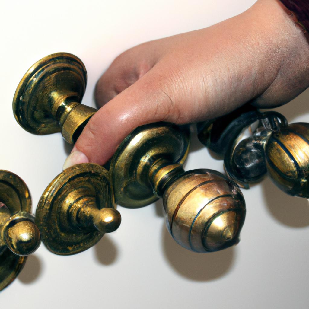 Person holding various door knobs