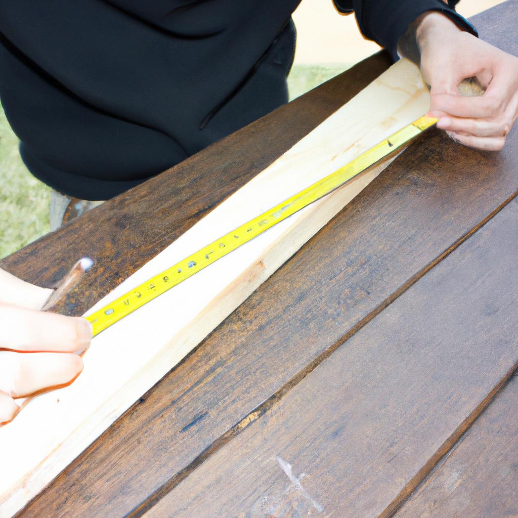 Person measuring and cutting wood