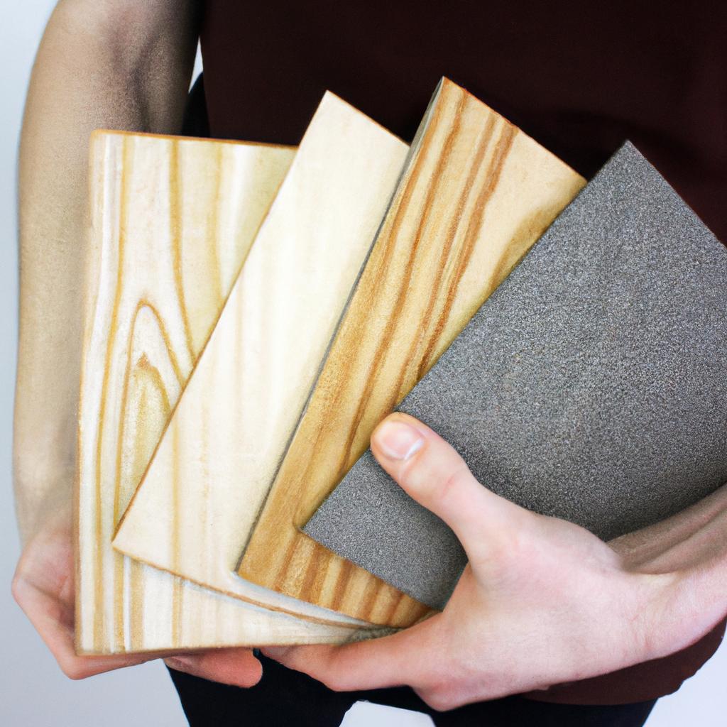 Person holding different plywood samples