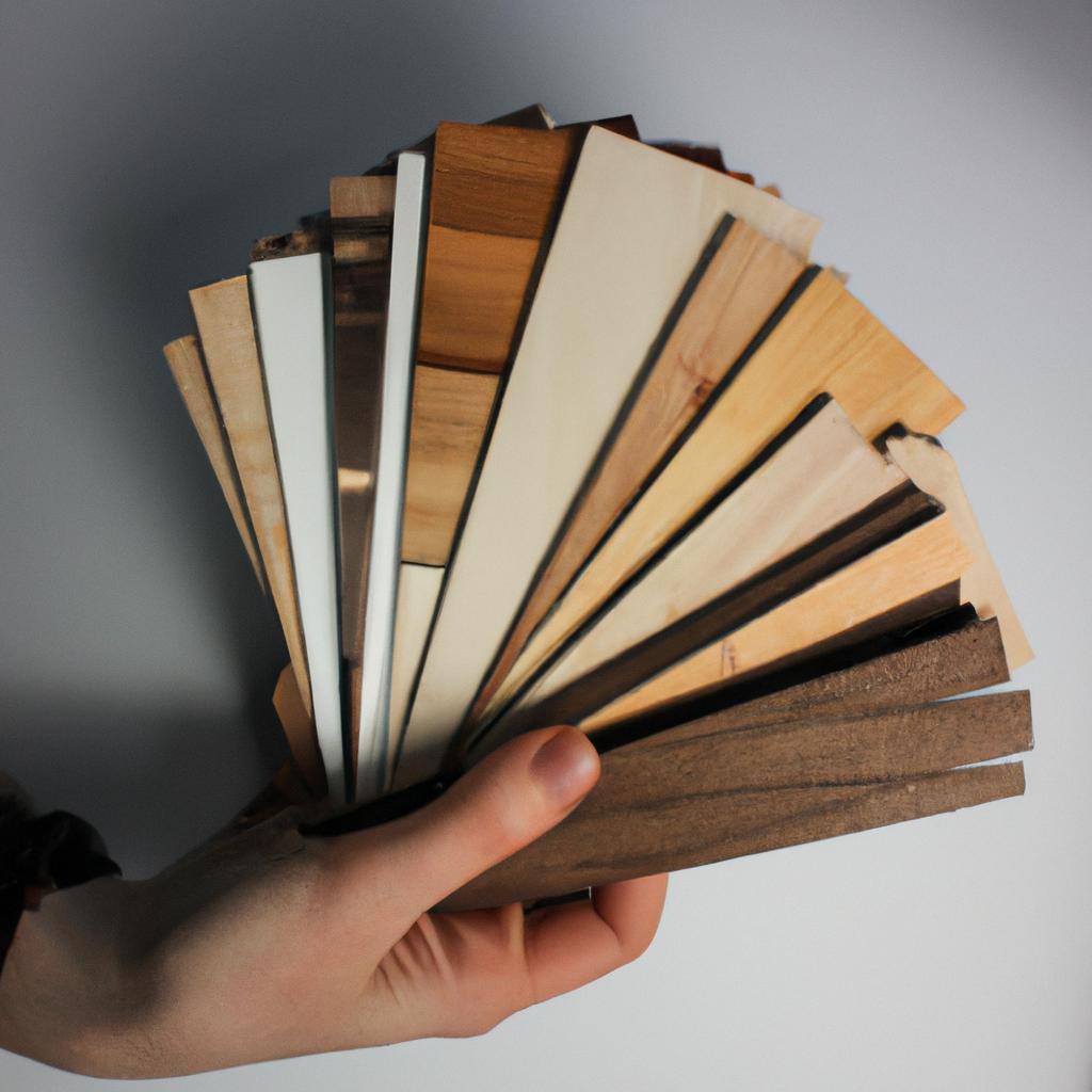 Person holding different wood samples
